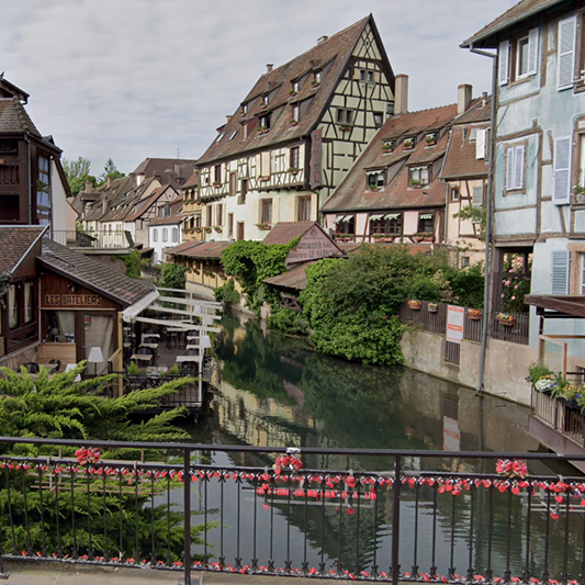 Picturesque view of a colorful, half-timbered street in Colmar, Alsace. Click to explore our guide to France beyond Paris.